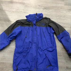 The North Face Royal Blue and Black womans Rain Jacket L with tuck away hood